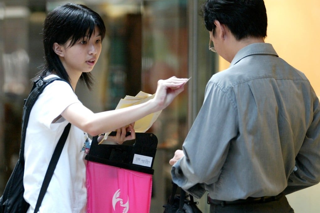 A woman sells stickers to raise money for charity in Central. Photo: Martin Chan