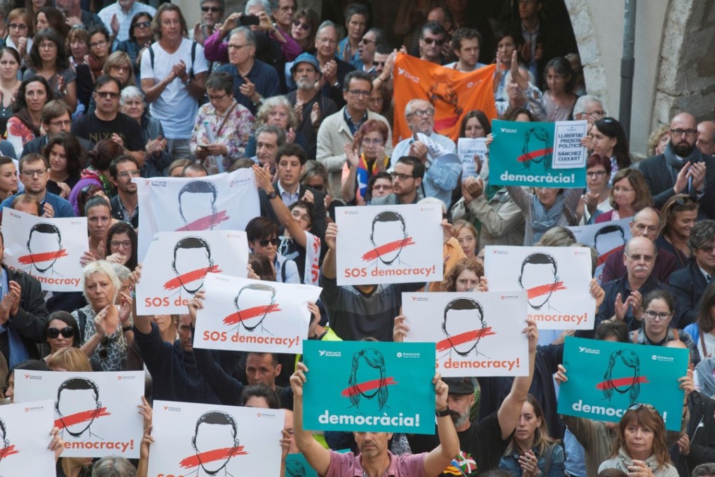 People gather to protest against the imprisonment of the President of the Omnium Cultural Jordi Cuixart and the President of the Catalan National Assembly Jordi Sanchez, during a rally held in Gerona, Catalonia, Spain, on October 17, 2017. Spain’s leading court ruled an independence referendum by the region is unconstitutional. Photo: EPA-EFE