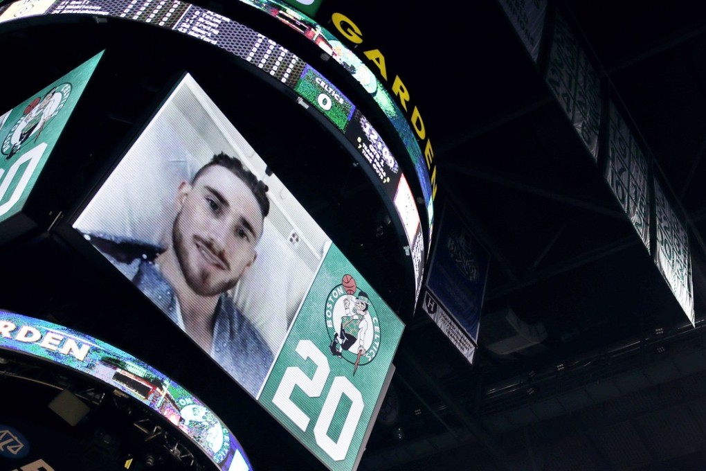 Boston Celtics forward Gordon Hayward is introduced to the crowd on the scoreboard from his hospital bed before the game against the Milwaukee Bucks. Photo: AP