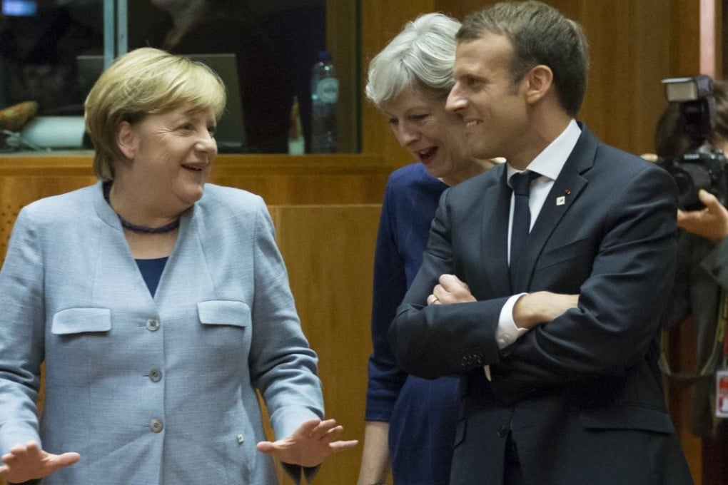 German Chancellor Angela Merkel, British Prime Minister Theresa May and French President Emmanuel Macron chat before the start of the first day of the European Council in Brussels, Belgium on October 19, 2017. Photo: EPA