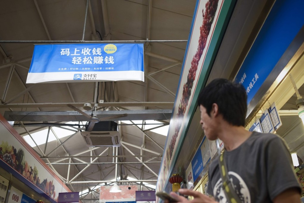 An Alipay advertisement in a Beijing market. The payments platform had 450 million users by 2016. Photo: AFP