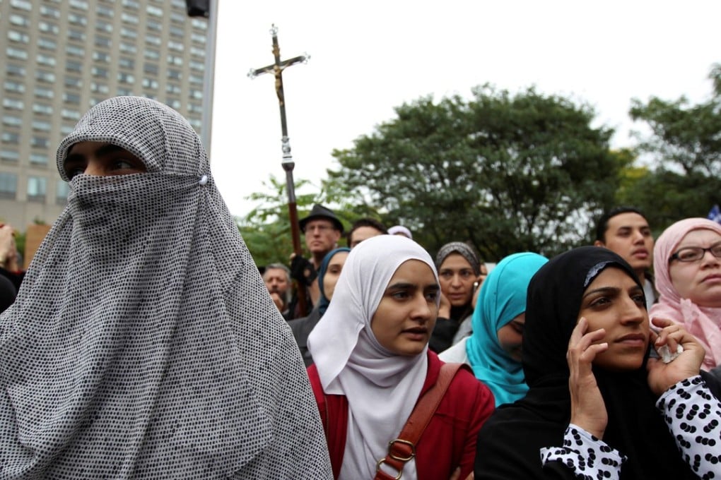 Women in traditional garb gather to protest against Quebec's proposed Charter of Values in Montreal in 2013. A new religious neutrality law will force people to uncover their faces to receive government services. Photo: Reuters