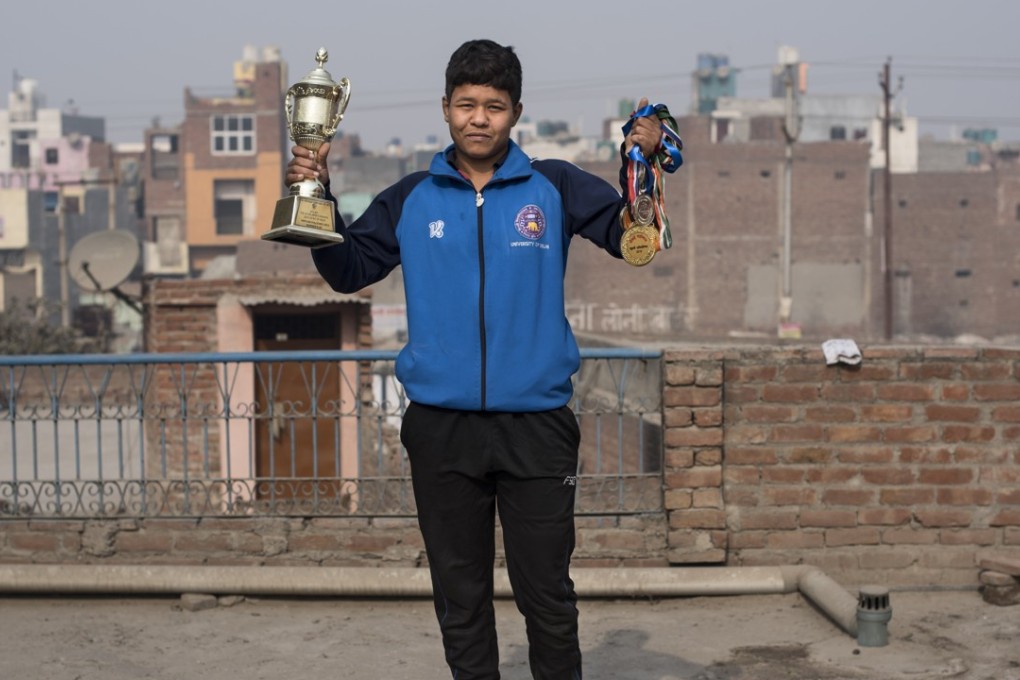 Neha Kumari with a trophy and medals she won in kushti competitions. Pictures: Miguel Candela