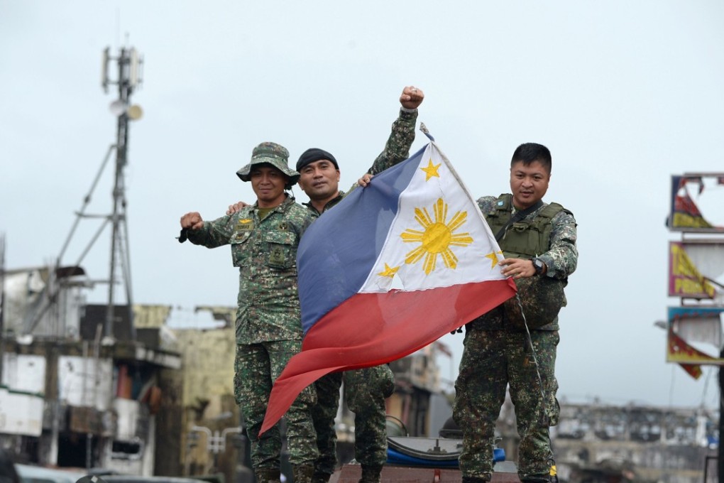 Philippine soldiers celebrate after President Rodrigo Duterte declared Marawi City ‘liberated’. Photo: AFP