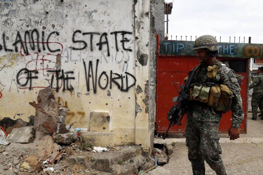 A Philippine marine conducts a clearing operation in the ruined city of Marawi. File photo: EPA