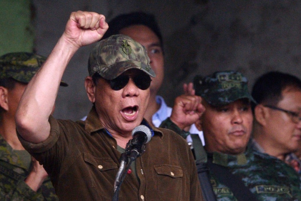 Philippines President Rodrigo Duterte raises a clenched fist as he declares Marawi “liberated” at a ceremony in the city on October 17, 2017. Photo: AFP