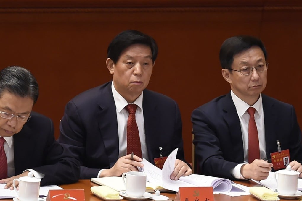 Zhao Leji (left) and Li Zhanshu (centre) sit next to Shanghai party secretary Han Zheng at the opening session of the Communist Party's national congress in the Great Hall of the People in Beijing on Wednesday. Photo: AFP
