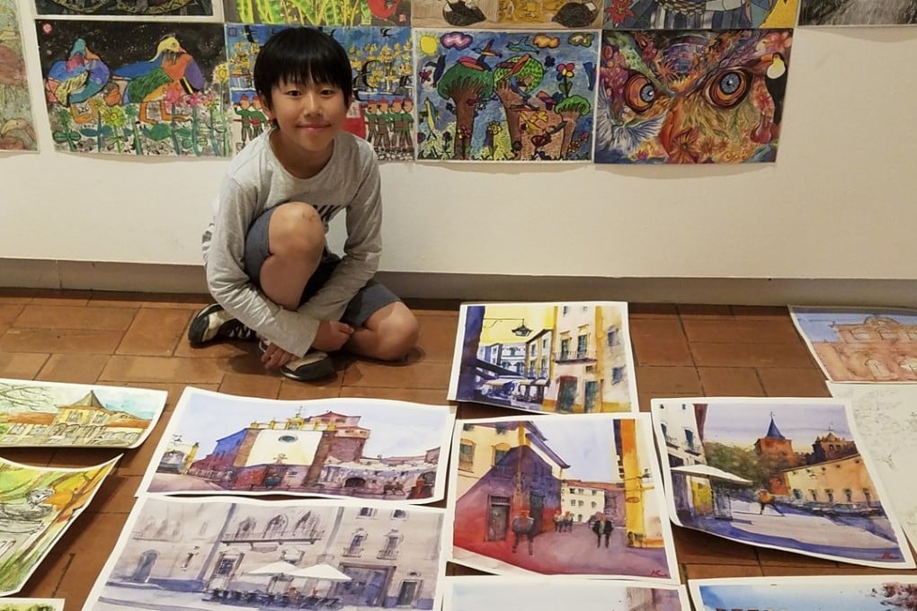 Kenny Lau, 12, with scenes he painted around the world. Photo: Handout
