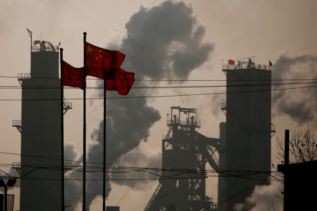 Chinese national flags flying near a steel factory in Hebei province. Industrial growth slowed to 6.3 per cent in the third quarter. Photo: Reuters