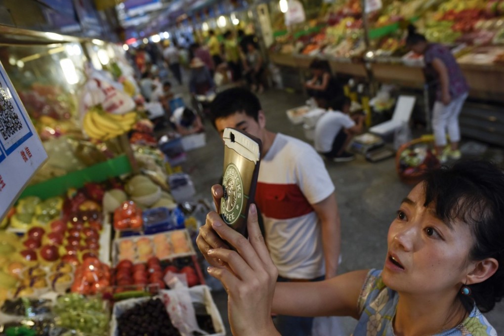 Will mobile payments in Hong Kong take off in big way any time soon? In China, its soaring popularity has reached the wet markets in the country. Photo: AFP