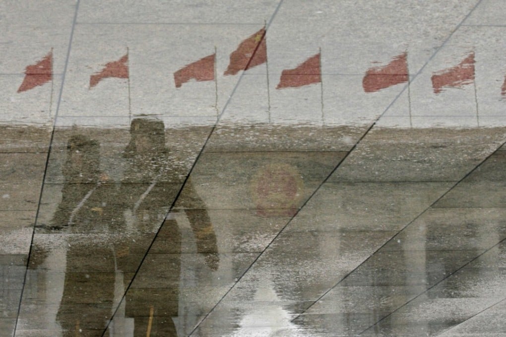 Policemen in a reflection as they patrol outside the Great Hall of the People in Beijing. After the balmy gardens of Mar-a-Lago in April, Presidents Xi and Trump will meet in the wintry chill of the Chinese capital next month – the likely contrast in weather no doubt reflecting the change in mood. Photo: AFP.