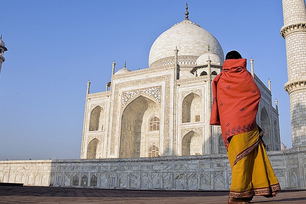 A woman looks up at the facade of the Taj Mahal in Agra, India. Photo: Post Magazine