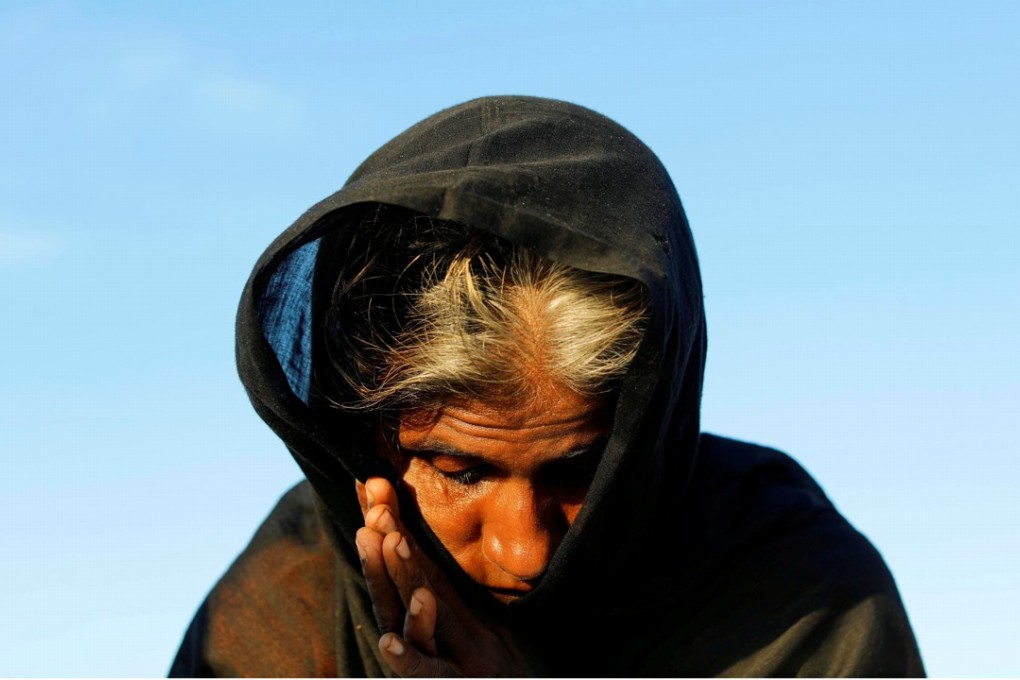A Rohingya refugee woman waits for permission from the Bangladeshi army to continue, after crossing from Myanmar into Teknaf, Bangladesh, on October 15. Photo: Reuters