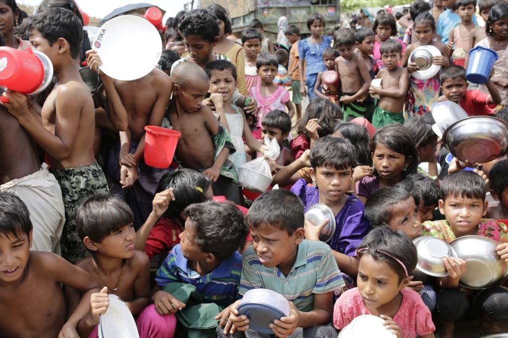Rohingya children wait outside a food centre to collect lunch at a camp in Bangladesh on October 11. Photo: EPA