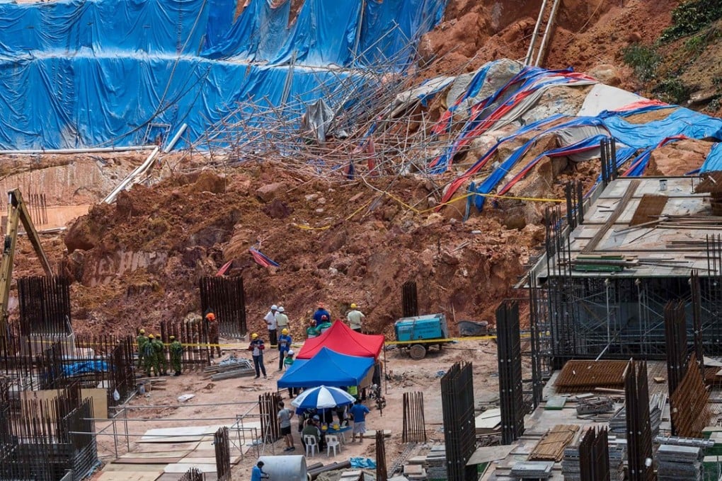 Rescuers search for victims of the landslide at a construction site in Tanjung Bungah, Penang. Photo: AFP