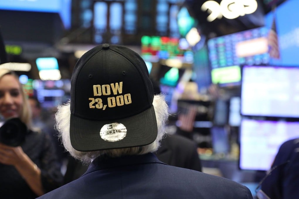 The Dow Jones Industrials ended Friday trade at 23,328.63, rising 165.6 points during the session. A trader wears a hat reading Dow 23,000 on the floor of the New York Stock Exchange on October 17. Photo: AFP