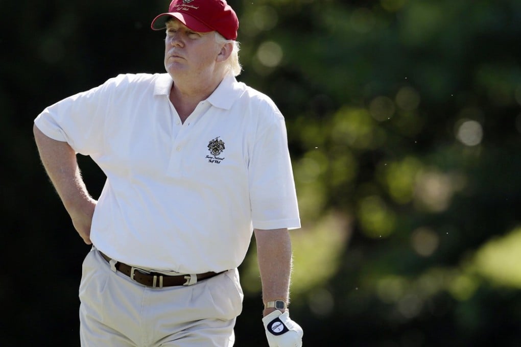 Another punishing day at the office, Mr President? Donald Trump spends one in five days on a golf course, says David Dodwell. Photo: AP