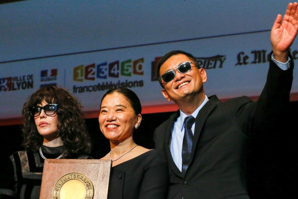 Director Wong Kar-wai (right) paid tribute to his wife Esther (centre) after he won the Lumière Award in Lyon on Friday. The award was presented by French actor Isabelle Adjani. Photo: Reuters