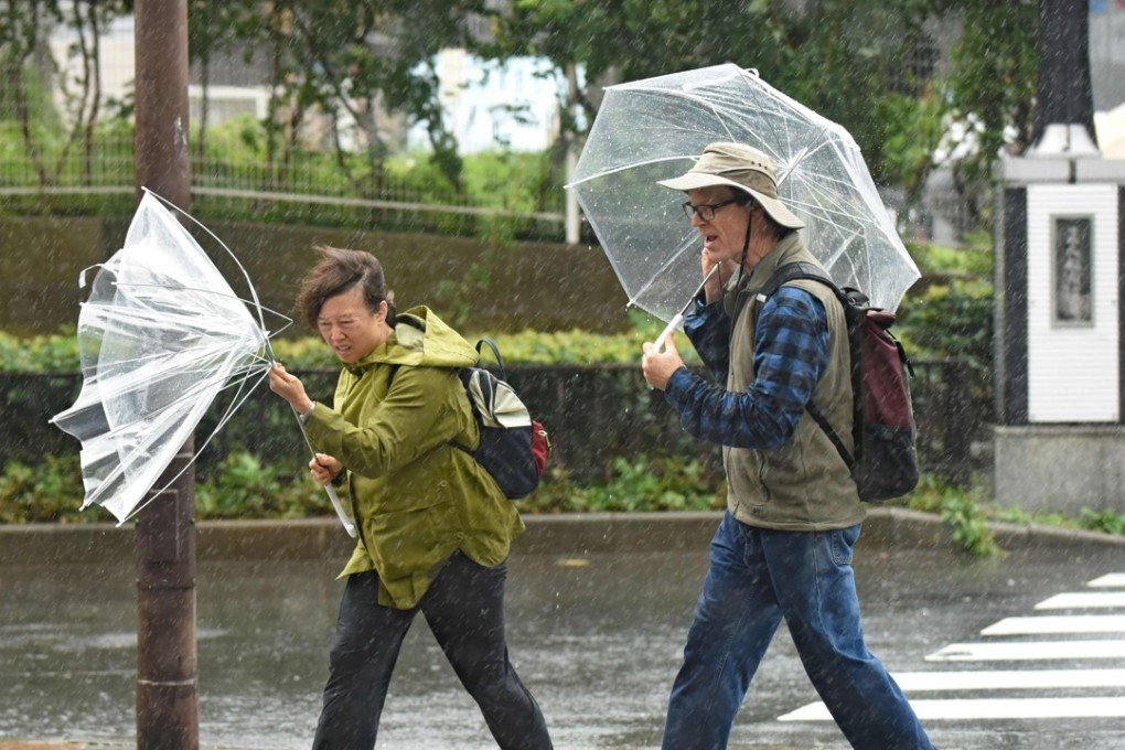 A woman battles strong gusts in Tokyo as a powerful typhoon barrelled toward Japan. Photo: AFP