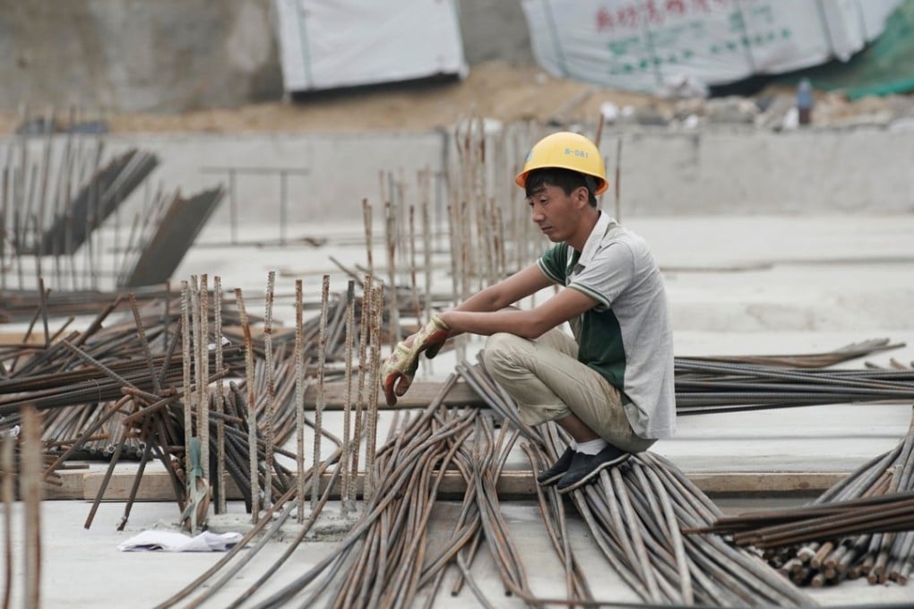 A labourer rests at a construction site in Beijing. Photo: Reuters