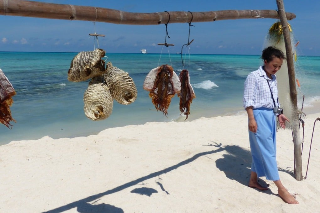 A tourist stands on a white sand beach on Silver Islet in the Paracel Islands. Photo: Liu Zhen