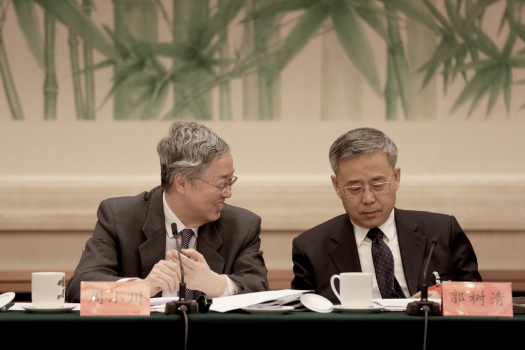 Zhou Xiaochuan, left, governor of the People's Bank of China (PBOC), left, pictured with Guo Shuqing this week at the Communist Party conference in Beijing. Photo: Bloomberg