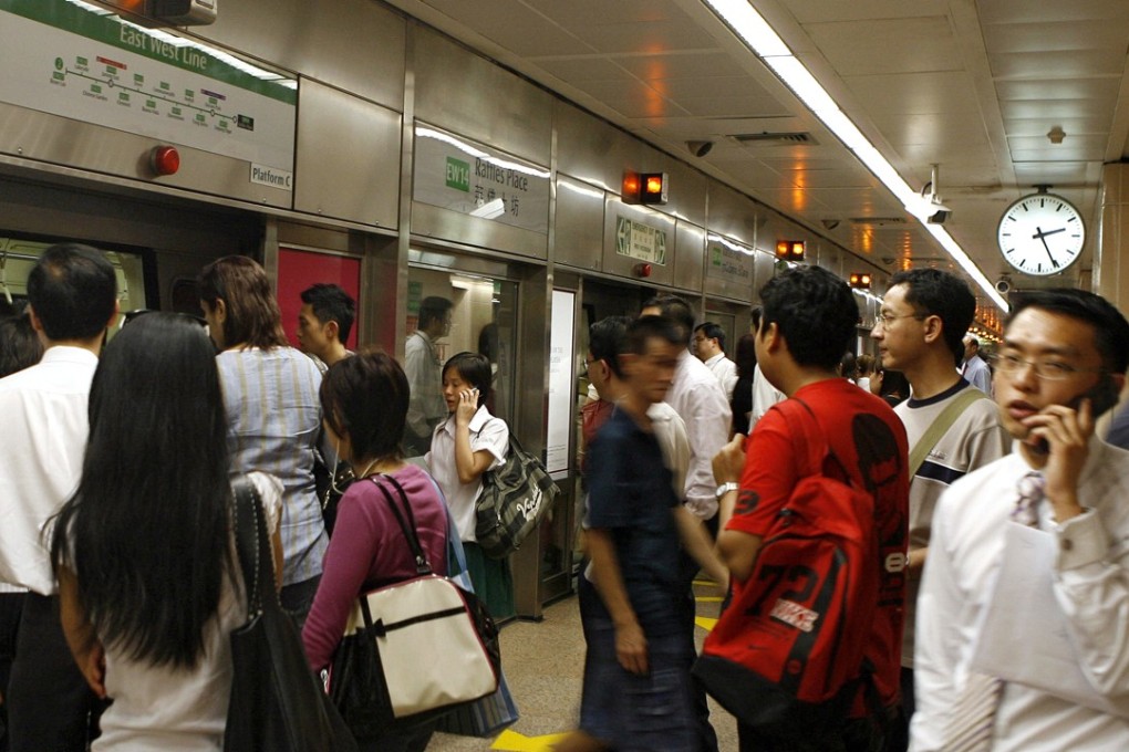 Unfortunate souls: Commuters at an MRT station in Singapore. Photo: AFP