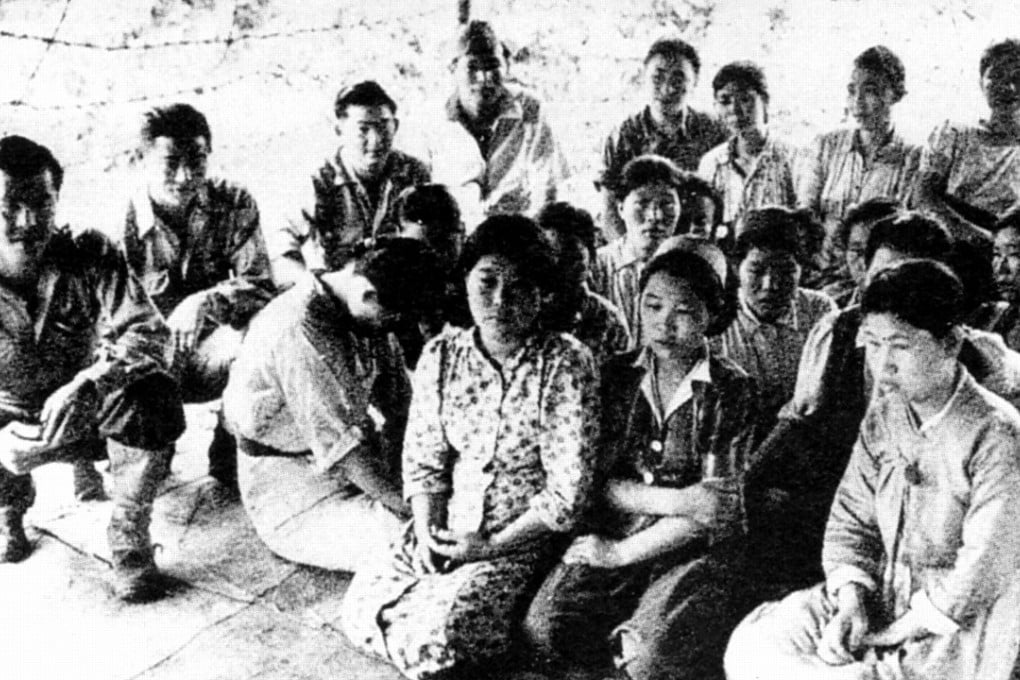 Young Chinese “comfort women” are pictured sitting with Japanese soldiers during the second world war. It is not known what year this image was taken.