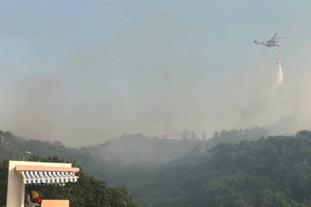 A helicopter water bombing the hill fire on Lamma Island on Tuesday. Photo: Facebook