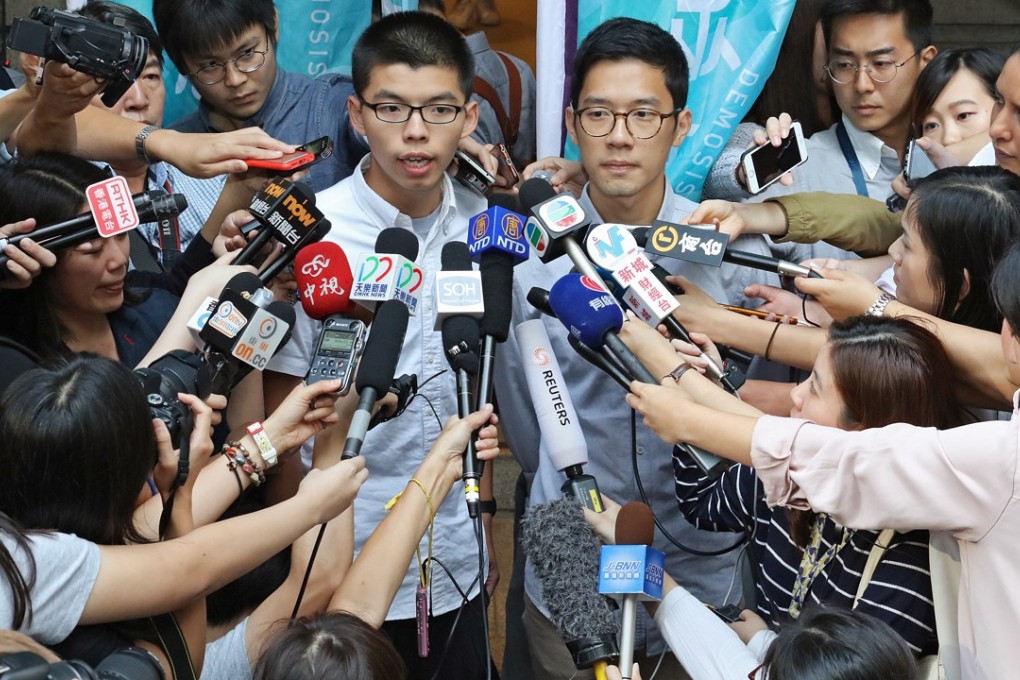 Joshua Wong (left) and Nathan Law speak to the media outside the Court of Final Appeal in Central after being released on bail. Photo: Felix Wong