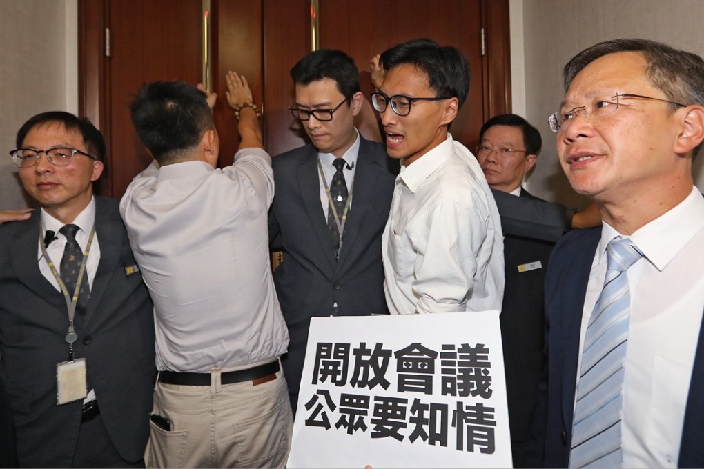 Pan-democrat Lawmakers protest outside meeting room during a closed door meeting of Committee on Rules of Procedure at the Legislative Council building in Tamar. Photo: Edward Wong