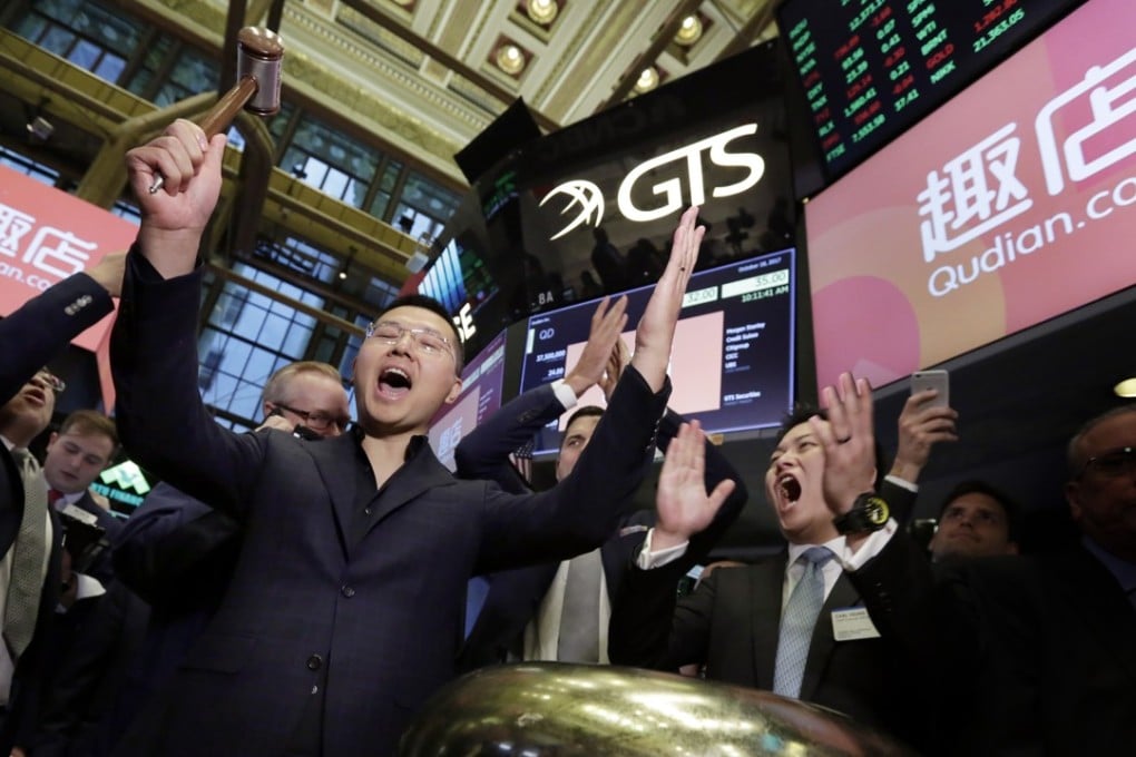 Qudian Inc. CEO Luo Min, left, and CFO Carl Yeung celebrate with a ceremonial bell ringing as their company's IPO starts trading, on the floor of the New York Stock Exchange, Wednesday, October 18, 2017. Photo: AP Photo