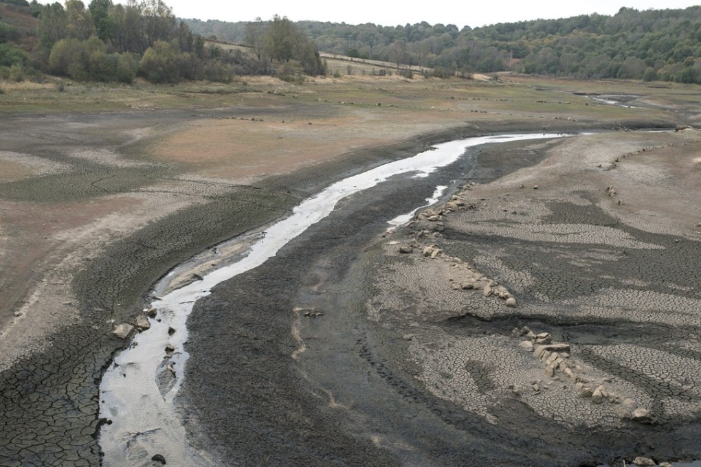 Broken soil dominates the river bed of the Mao river that shrunk to a small creek near the village of Montederramo, in Galicia, northwestern Spain. Photo: EPA-EFE