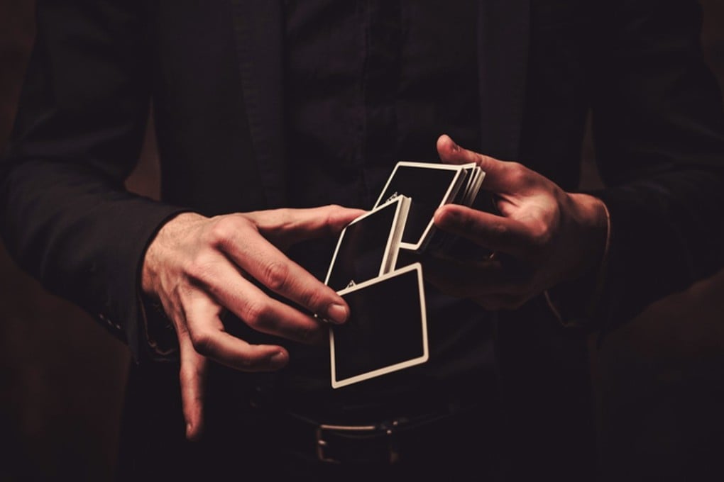 Watch closely – a magician’s hands move in mysterious ways with a deck of cards.