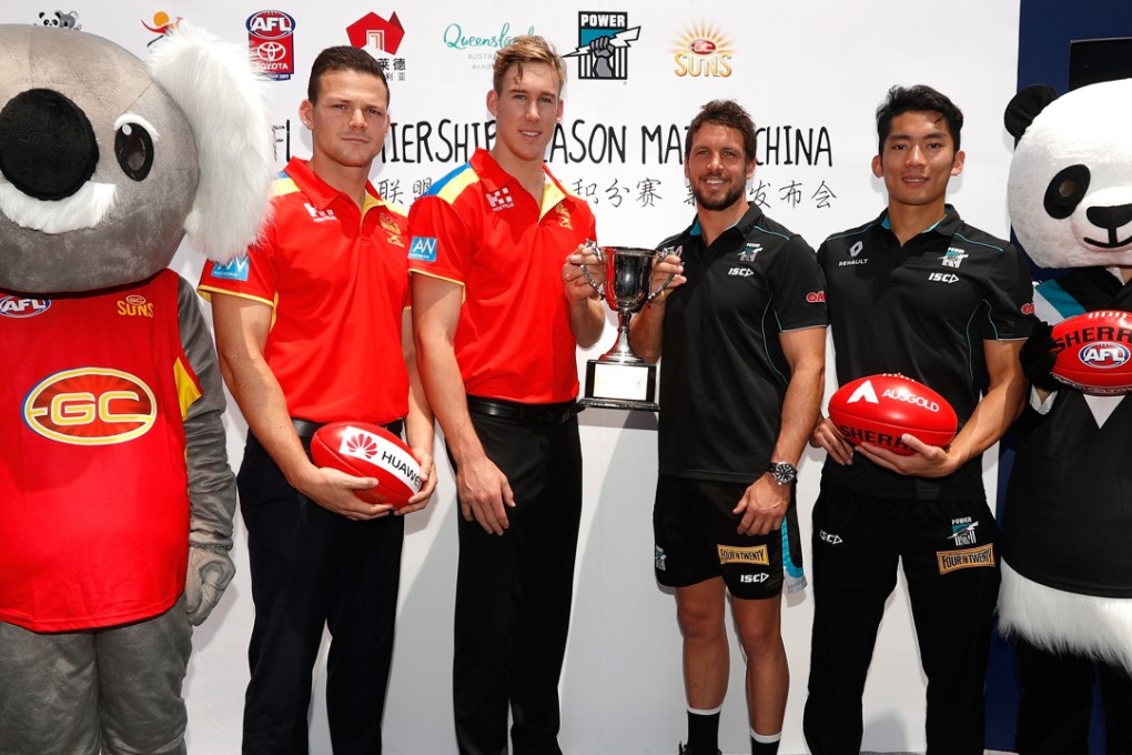 Steven May and Tom Lynch of the Suns (left) pose with Travis Boak and Chen Shaoliang of the Power during a press conference ahead of their first Australian Rules game in Shanghai earlier this year. Photo: Michael Willson / AFL Media