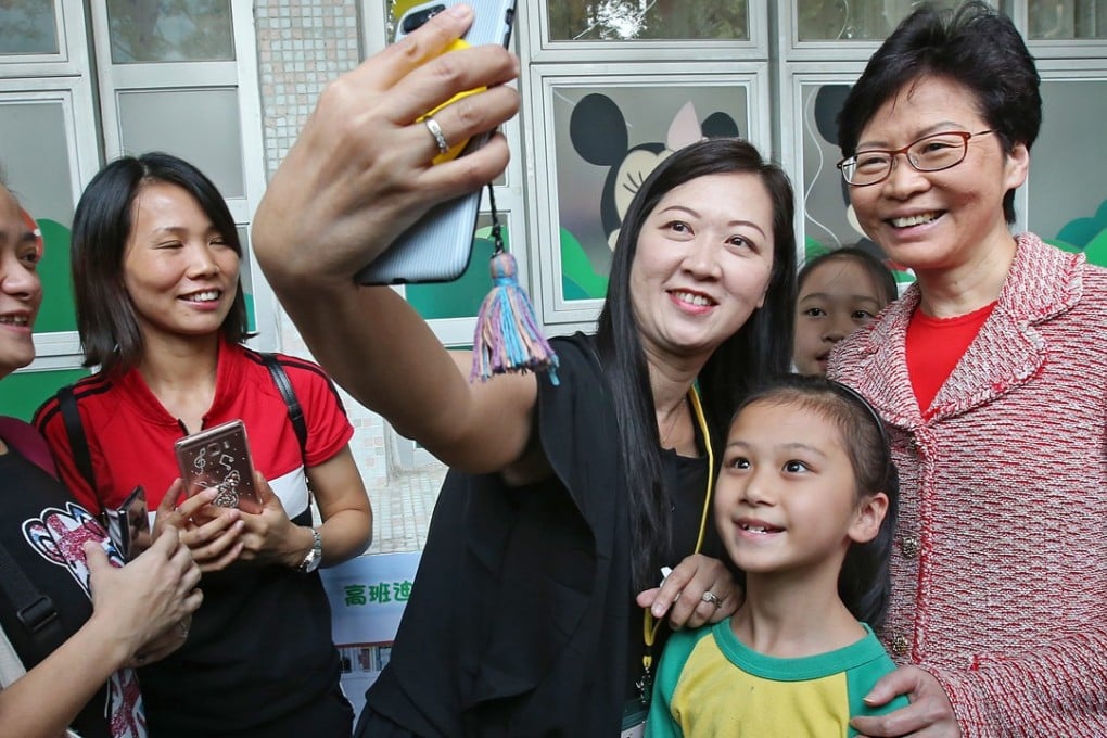 Chief Executive Carrie Lam (right) posing for a selfie with students and a teacher at Tsz Wan Shan in Kowloon. Photo: David Wong