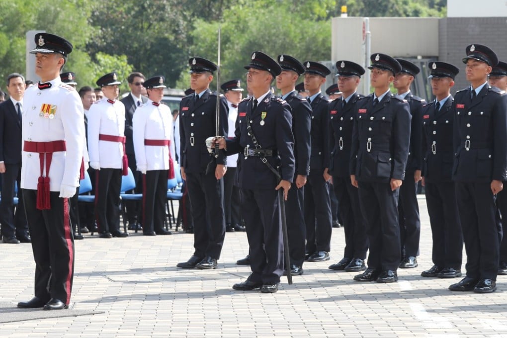 Director of Fire Services Daryl Li (left) leads representatives of the Fire Services Department, work unions, civilian staff and retirees in paying tribute on Thursday. Photo: K.Y. Cheng