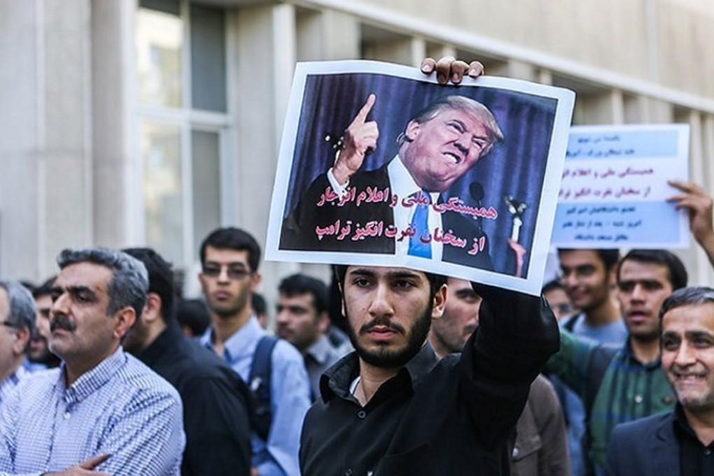 An Iranian student holds up an anti-Trump poster during a protest against the US president’s speech on Iran, in Tehran on October 14. Photo: Reuters