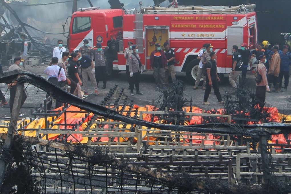 Indonesian forensic policemen work after the blaze in Tangerang Kota, Banten province. Photo: AFP