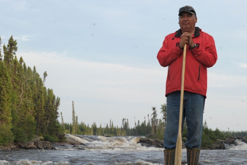 Don Saganash, a Cree trapper monitoring the traditional land of the Cree First Nations, surveys the Broadback River in Waswanipi, Canada. Photo: Agence France-Presse