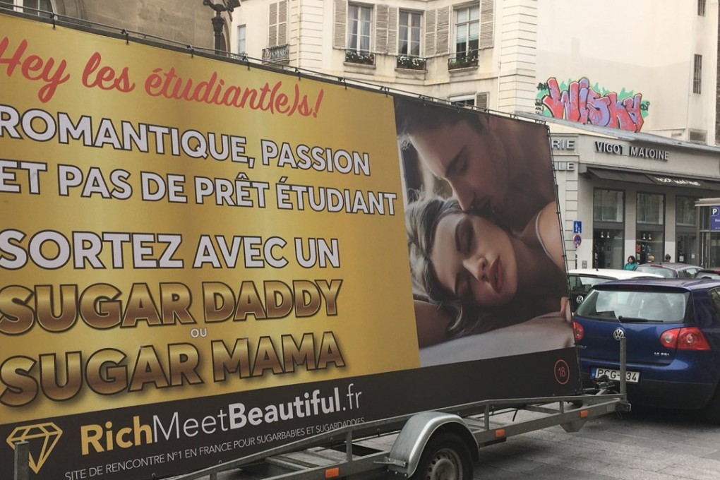 An advertising board of the dating site “RichMeetBeautiful” reading “students, romantic, passion and no student loan, meet a Sugar Daddy or a Sugar Mama”. Photo: AFP