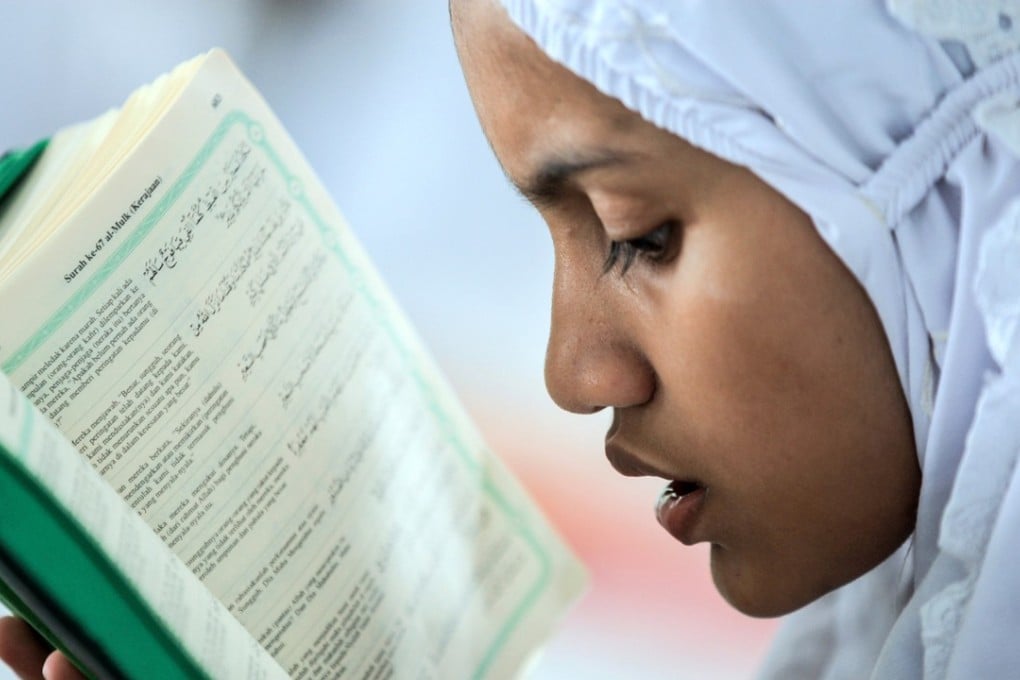 An Indonesian student reads the Koran on the first day of Ramadan in May. Given the challenge of growing extremism in Southeast Asia, it is important to seek solutions that recognise the importance of inclusive religious identities and the institutionalisation of tolerance at all levels of society. Photo: EPA