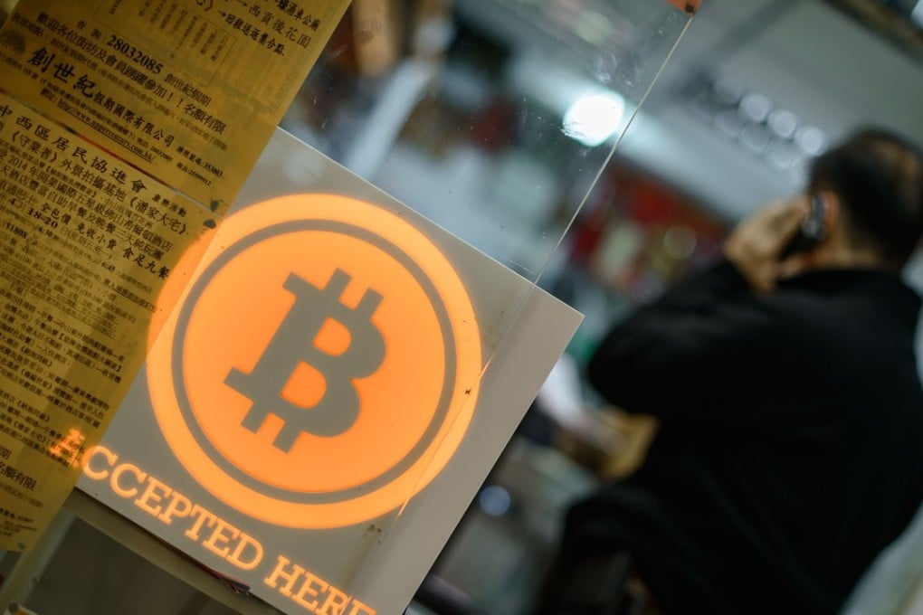 A man talks on a mobile phone during the opening ceremony of the first bitcoin retail shop in Hong Kong in 2014. Photo: AFP