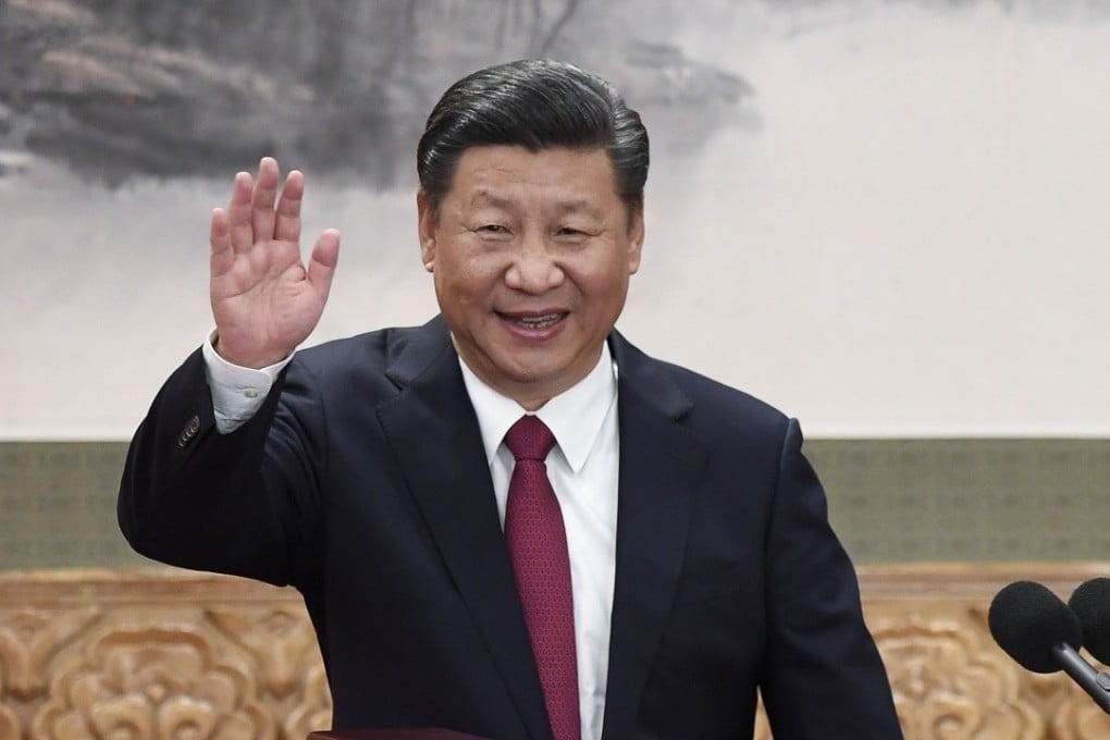 President Xi Jinping waves during the introduction of the new Politburo Standing Committee in Beijing. Photo: AFP