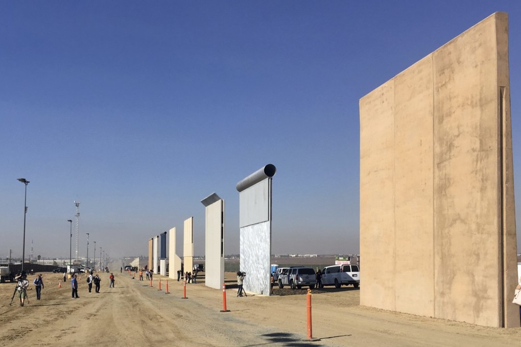 People look at prototypes of the proposed US-Mexico border wall on outside San Diego. Photo: AP