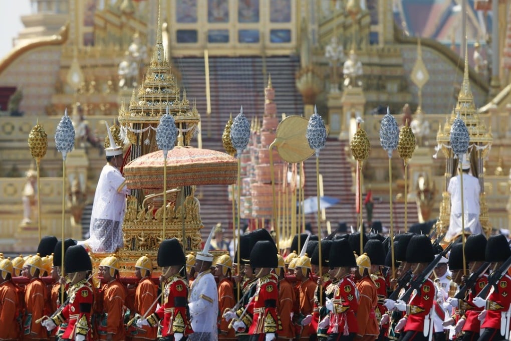 Members of the Thai military carrying the royal relics (left) and ashes (right) of the late King Bhumibol Adulyadej on palanquins march in a procession at the Royal Crematorium in Bangkok. Photo: EPA