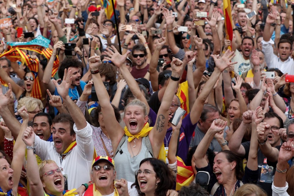 People celebrate after the Catalan regional parliament passes the vote of the independence from Spain in Barcelona. Photo: Reuters