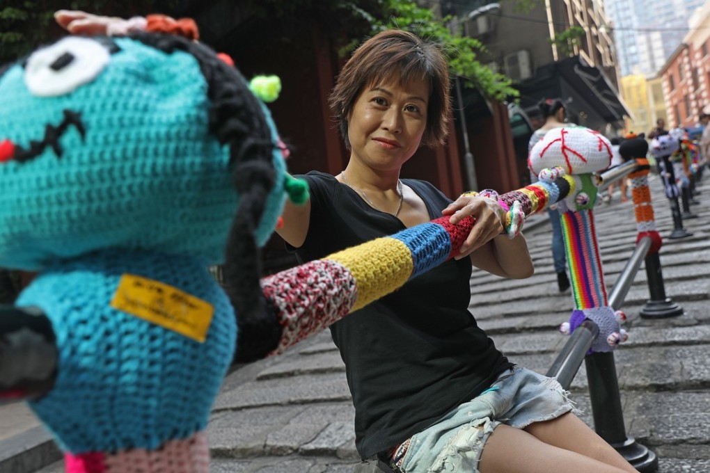 Yarn artist Esther Poon Suk-han working on an installation on Pottinger Street in Central. Photo: Sam Tsang