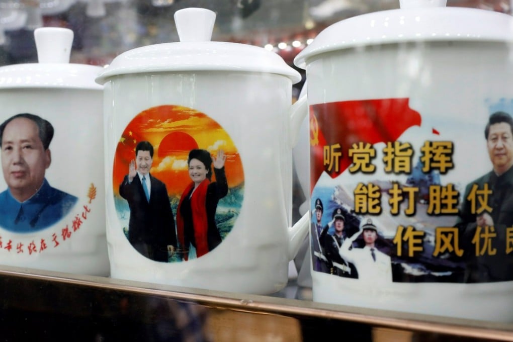 Souvenir cups with images of Chairman Mao Zedong and Chinese President Xi Jinping on sale during the Communist Party’s 19th National Congress. Photo: Reuters
