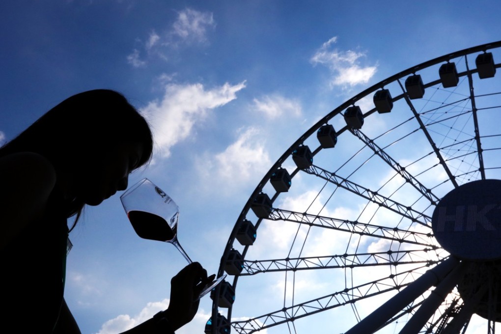 A woman enjoys a glass of red wine at Hong Kong’s Wine and Dine Festival last year. Photo: Felix Wong